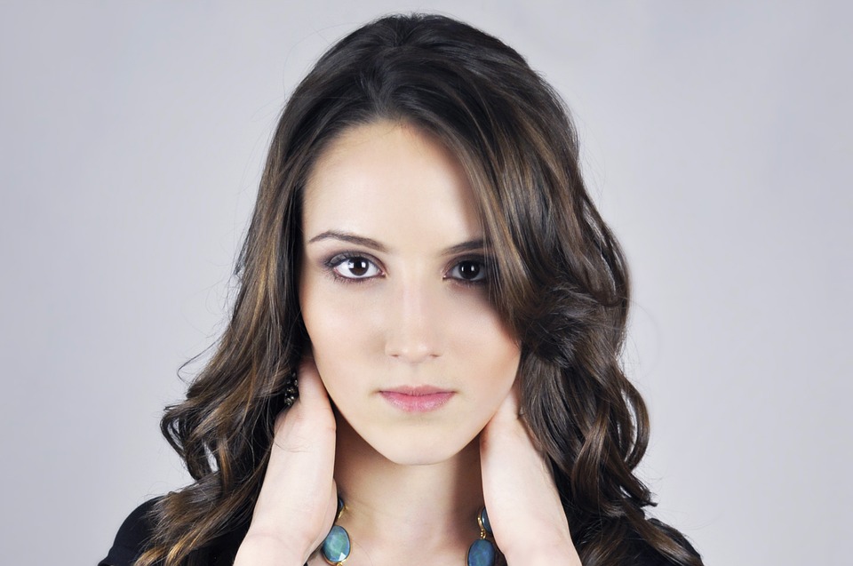 gorgeous girl holding the back of her neck